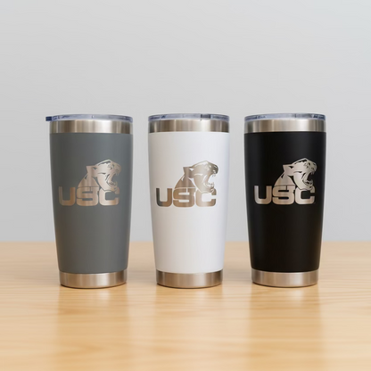 Three insulated tumblers with USC logo on a wooden surface and light gray background